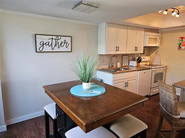 a dining room with a table chairs and a flat screen tv