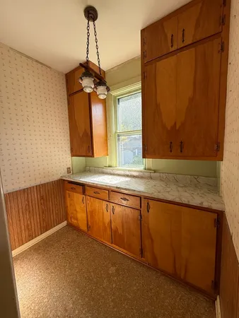 a kitchen with granite countertop a stove and a sink