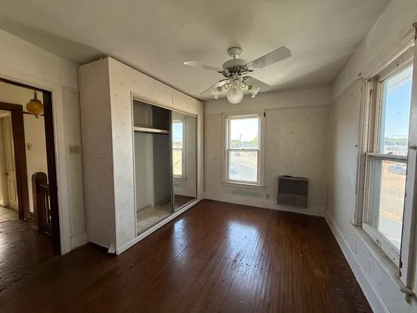 a view of a room with wooden floor