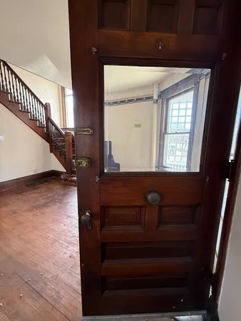 a view of entryway and hall with wooden floor