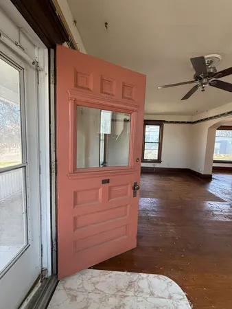 a view of room with window and a ceiling fan