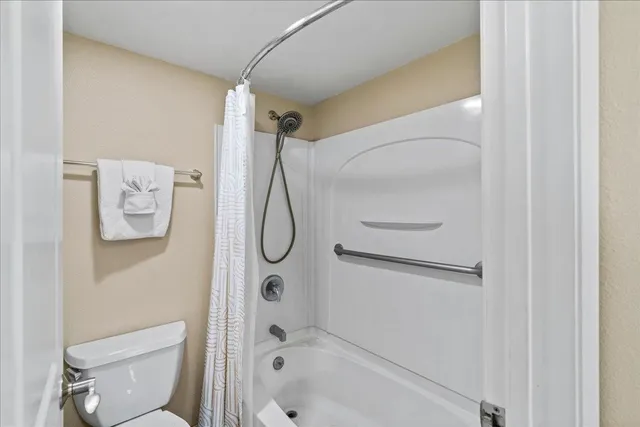 a bathroom with a shower a toilet and a shower