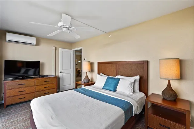 a bedroom with a bed and a flat screen tv