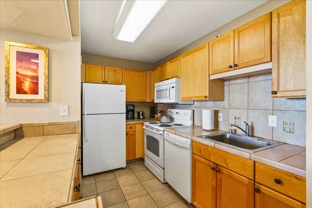 a kitchen with a sink cabinets and appliances