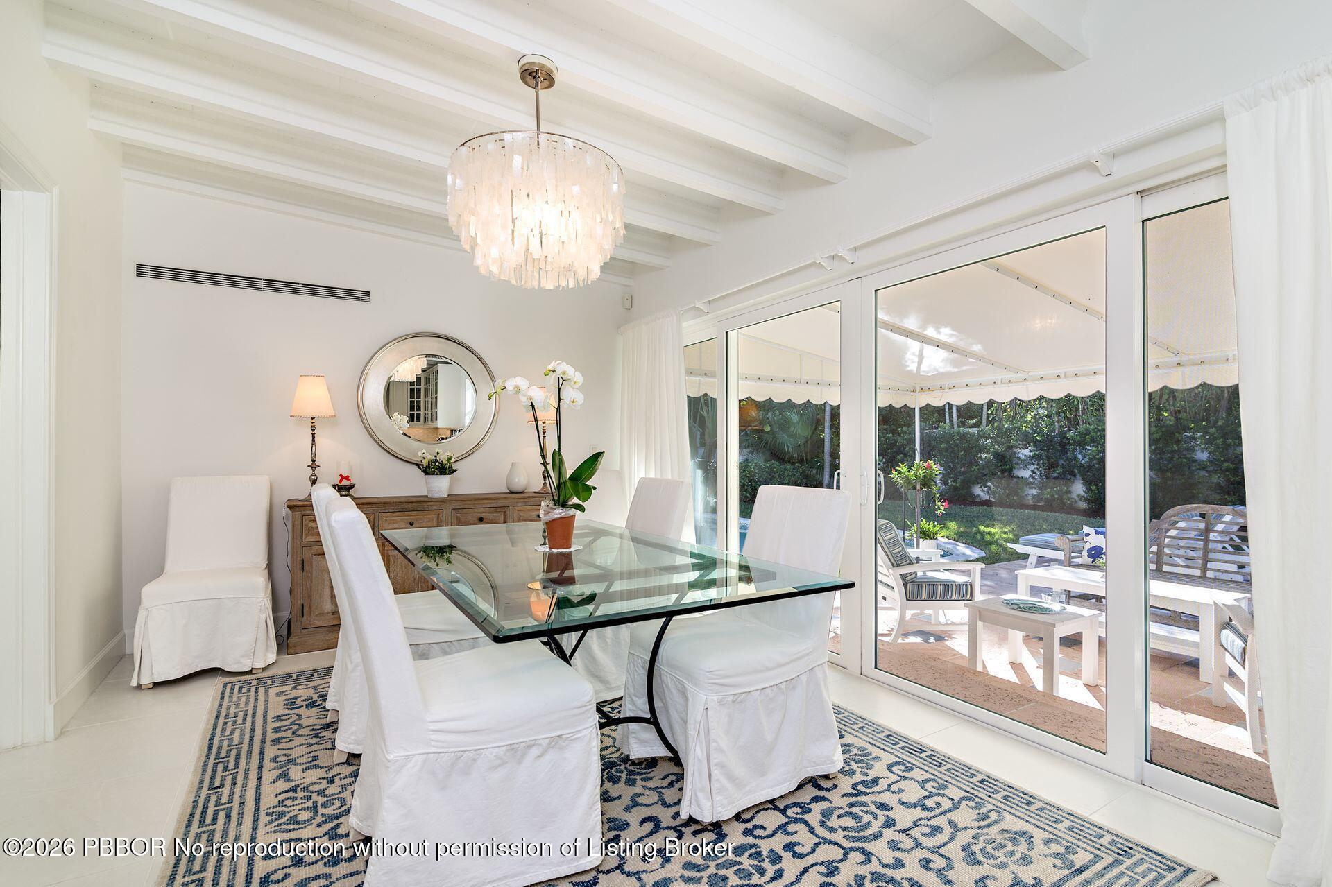 224 Churchill Road West Palm Beach, FL 33405 - Photo 9 of 33 a view of a dining room with furniture a chandelier and wooden floor