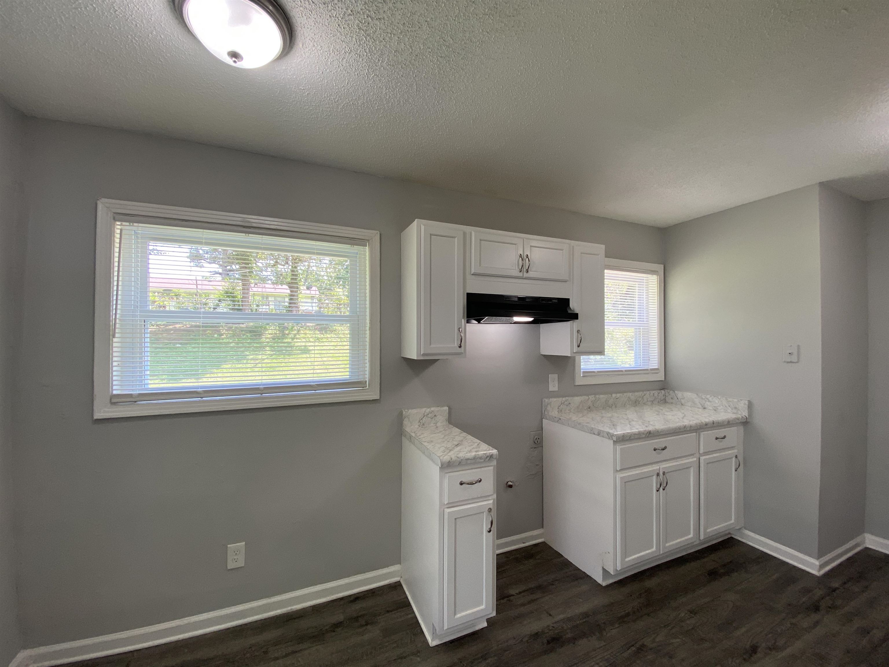 667 West Raines Road Memphis, TN 38109 - Photo 11 of 15 a kitchen with a stove a sink and a window