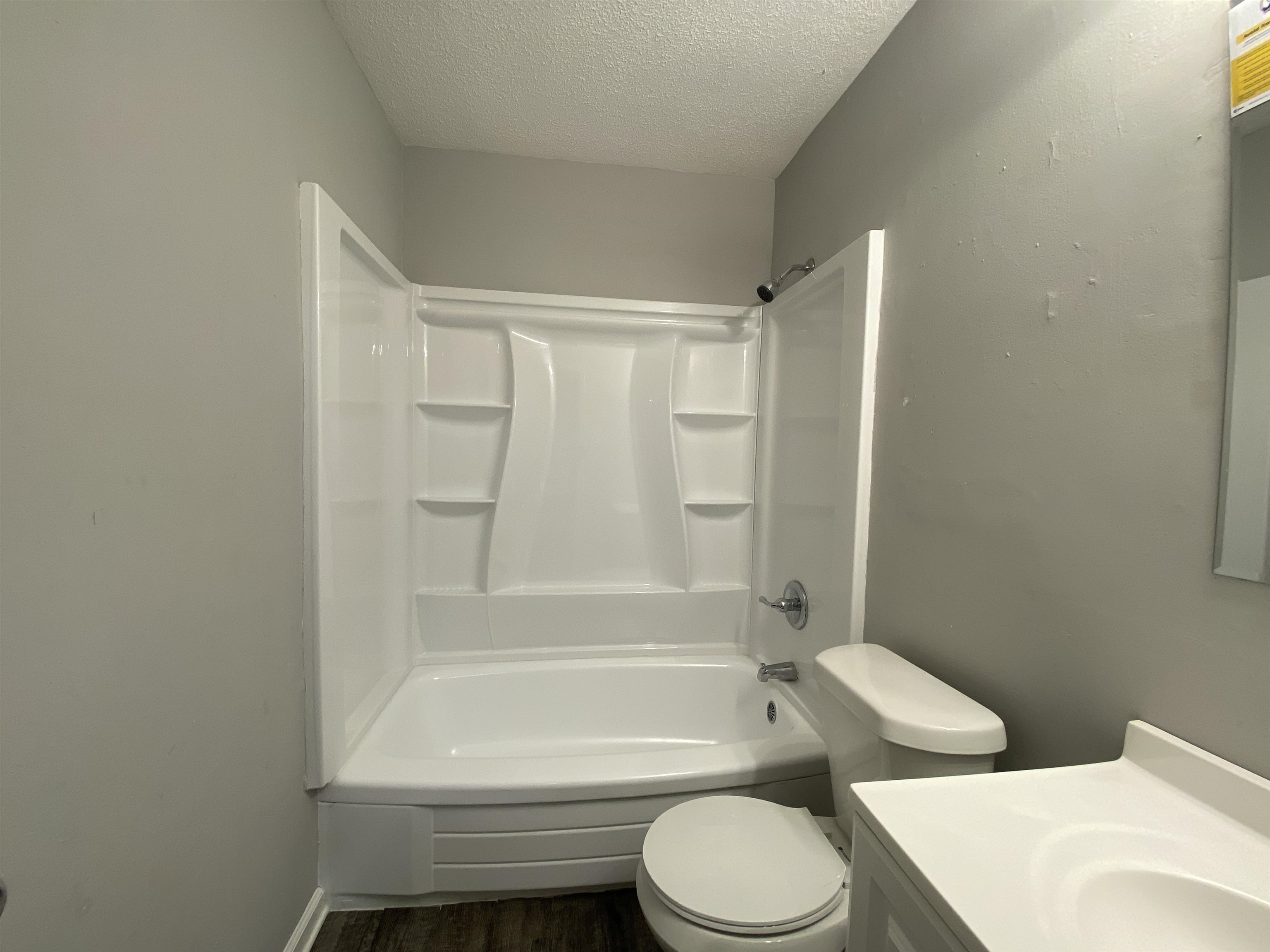 667 West Raines Road Memphis, TN 38109 - Photo 13 of 15 a bathroom with a toilet and a bath tub