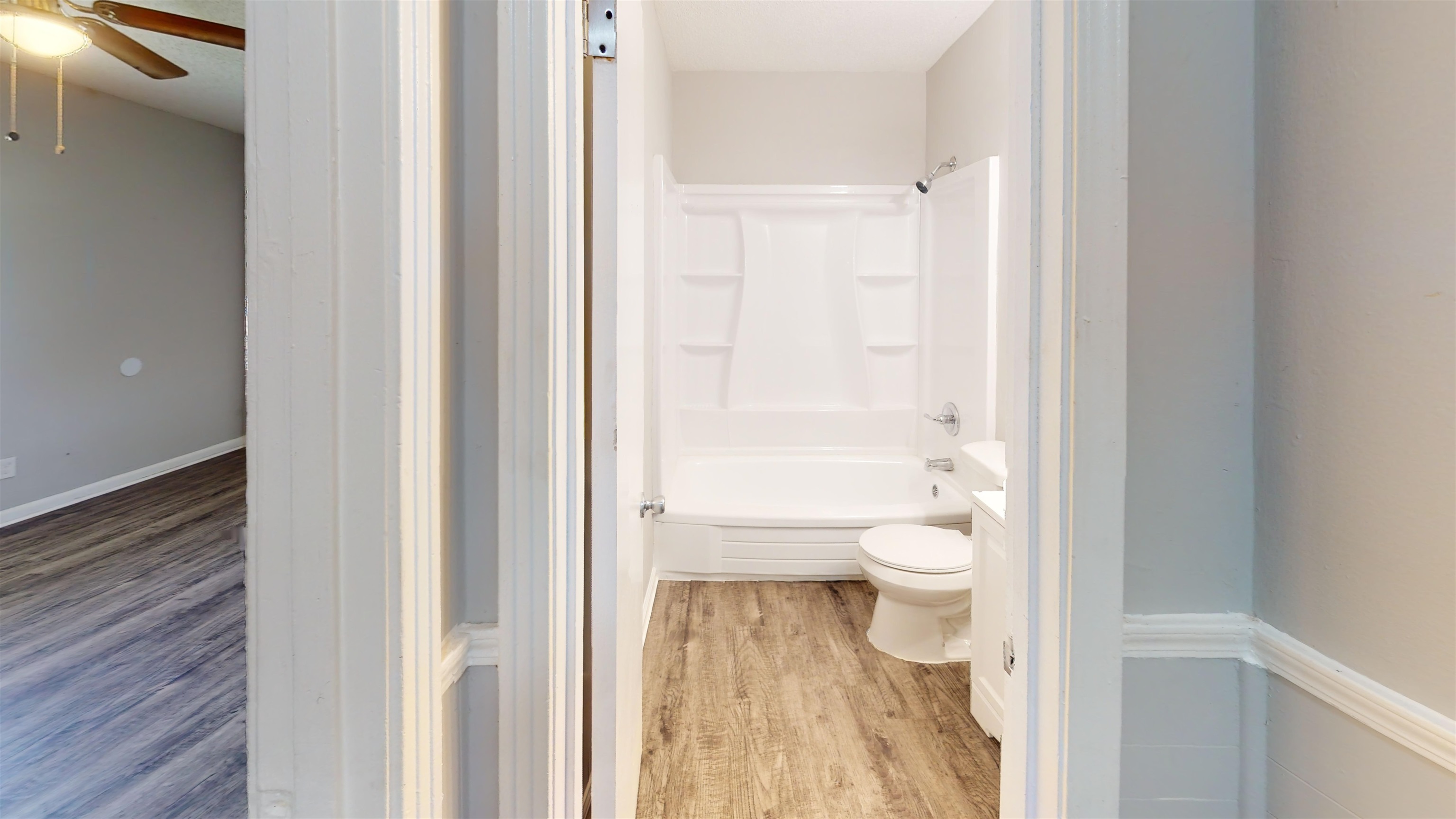 667 West Raines Road Memphis, TN 38109 - Photo 3 of 15 a bathroom with a granite countertop toilet a sink and a large mirror