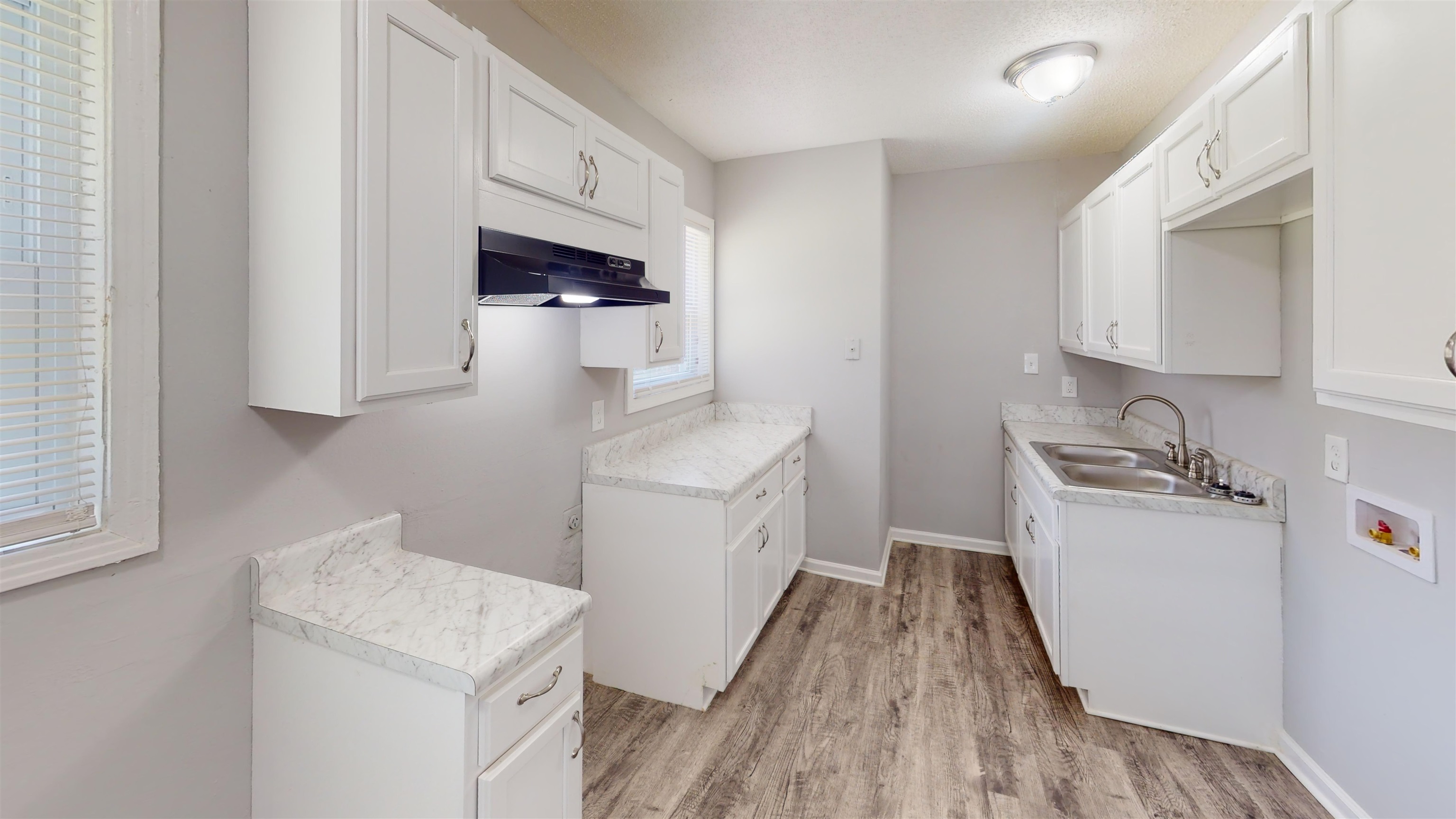 667 West Raines Road Memphis, TN 38109 - Photo 7 of 15 a kitchen with a sink a stove and cabinets