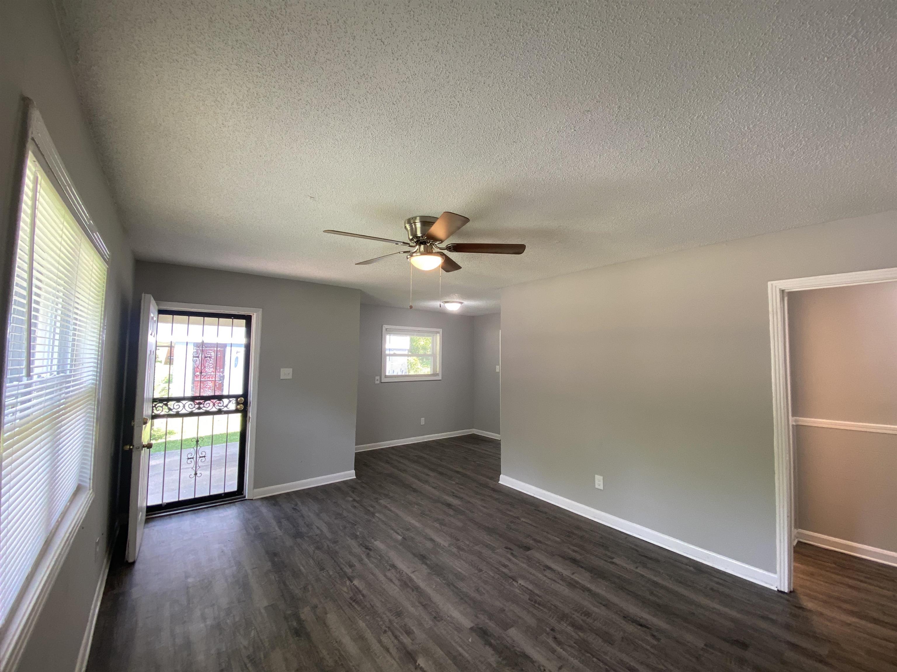 667 West Raines Road Memphis, TN 38109 - Photo 9 of 15 an empty room with wooden floor and windows