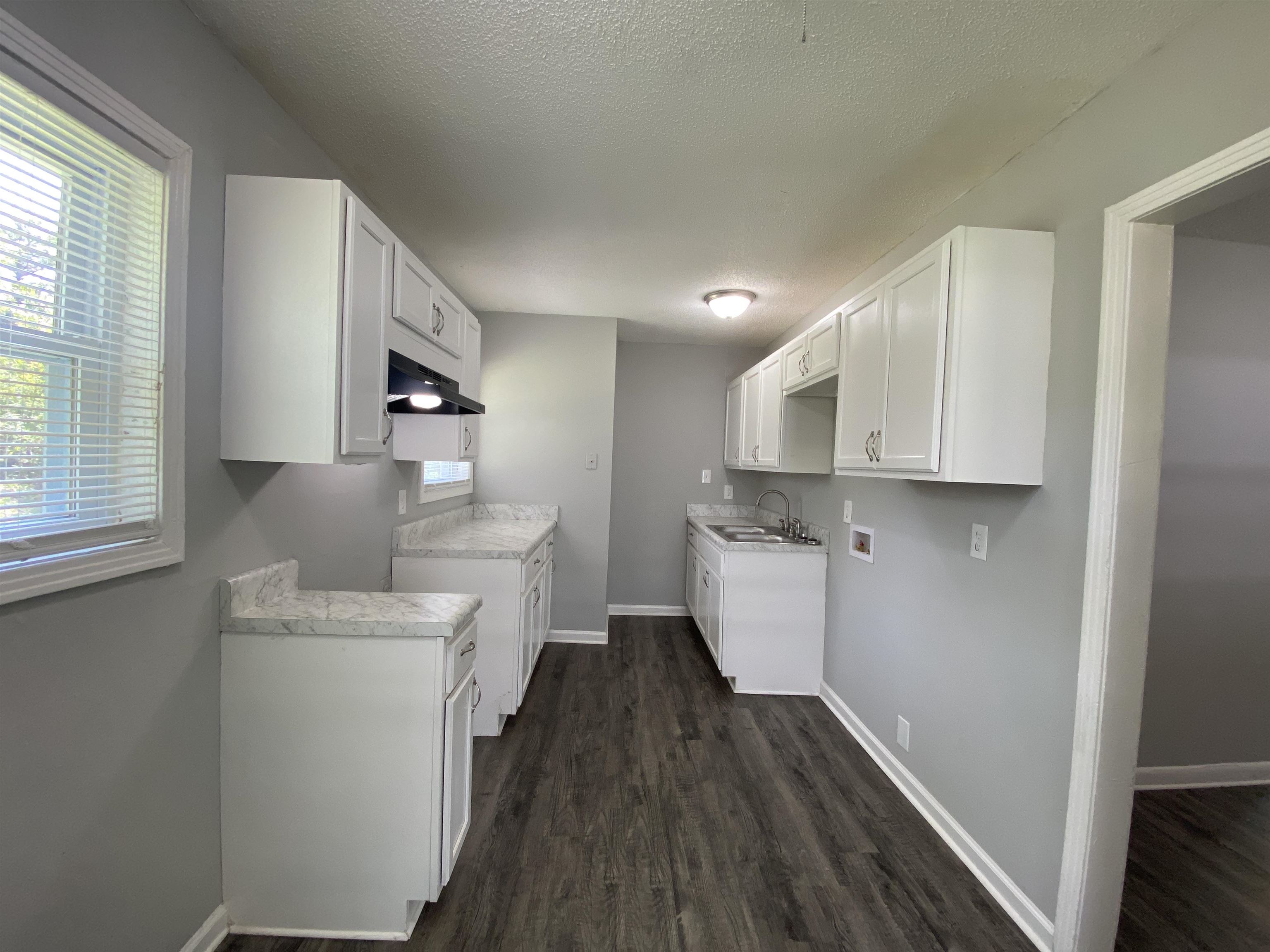 667 West Raines Road Memphis, TN 38109 - Photo 10 of 15 a kitchen with a white cabinets stove and sink