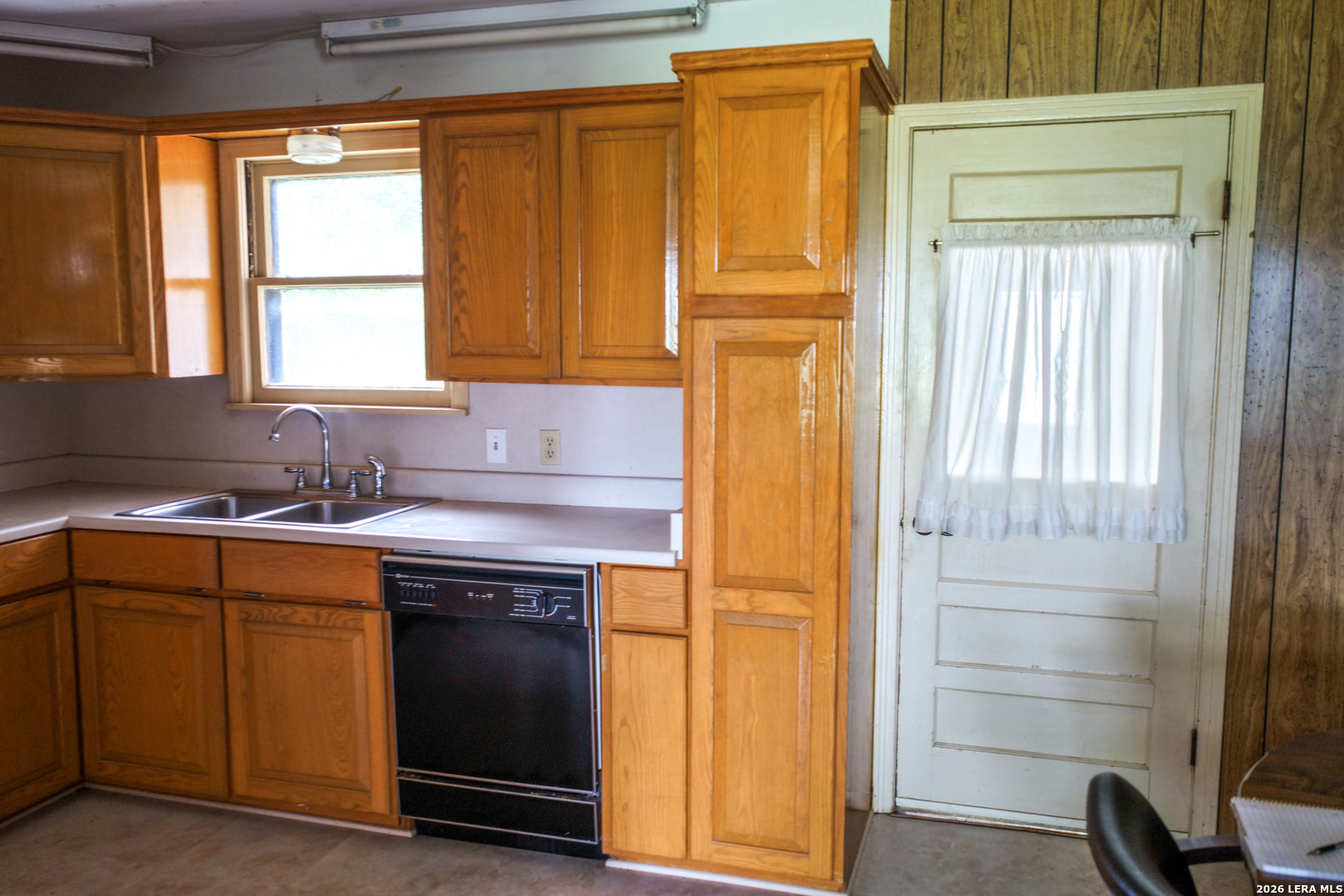 430 Watts Road Kingsbury, TX 78638 - Photo 31 of 37 a kitchen with a sink cabinets and a window