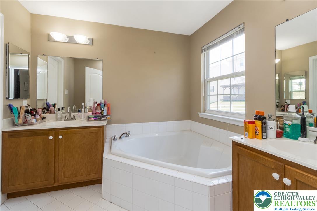 3566 Penfield Way Nazareth, PA 18064 - Photo 42 of 47 A deep soaking tub and twin vanities define this comfortable bathroom space.
