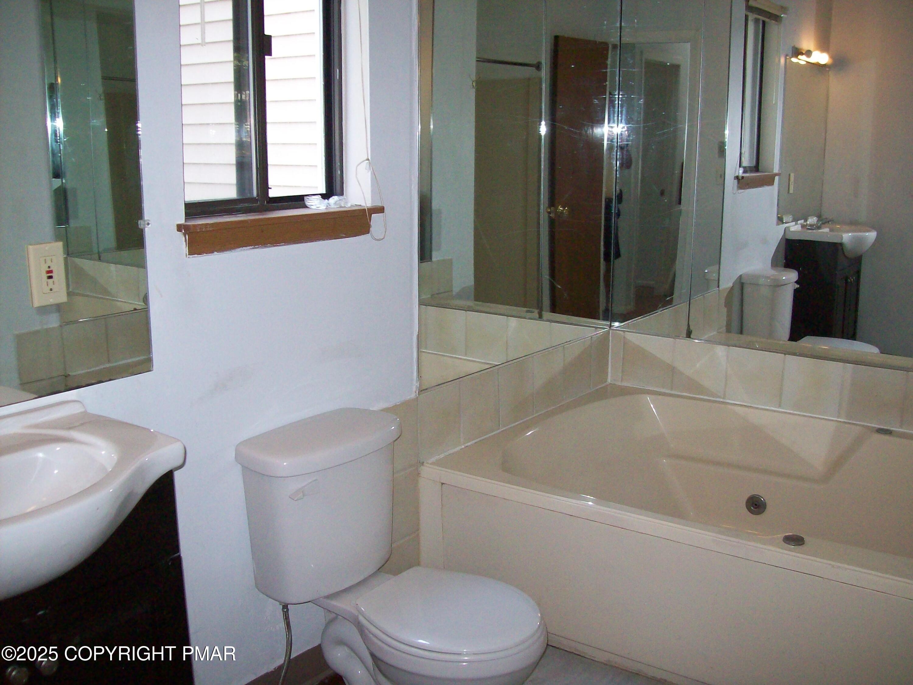 3314 Windermere Drive Bushkill, PA 18324 - Photo 10 of 23 a white toilet sitting next to a bathtub