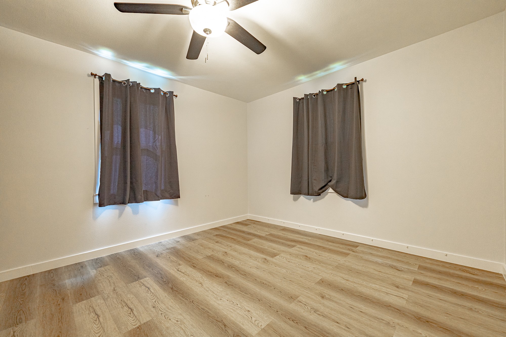 421 West Runk Street Shiner, TX 77984 - Photo 12 of 18 a view of an empty room with wooden floor