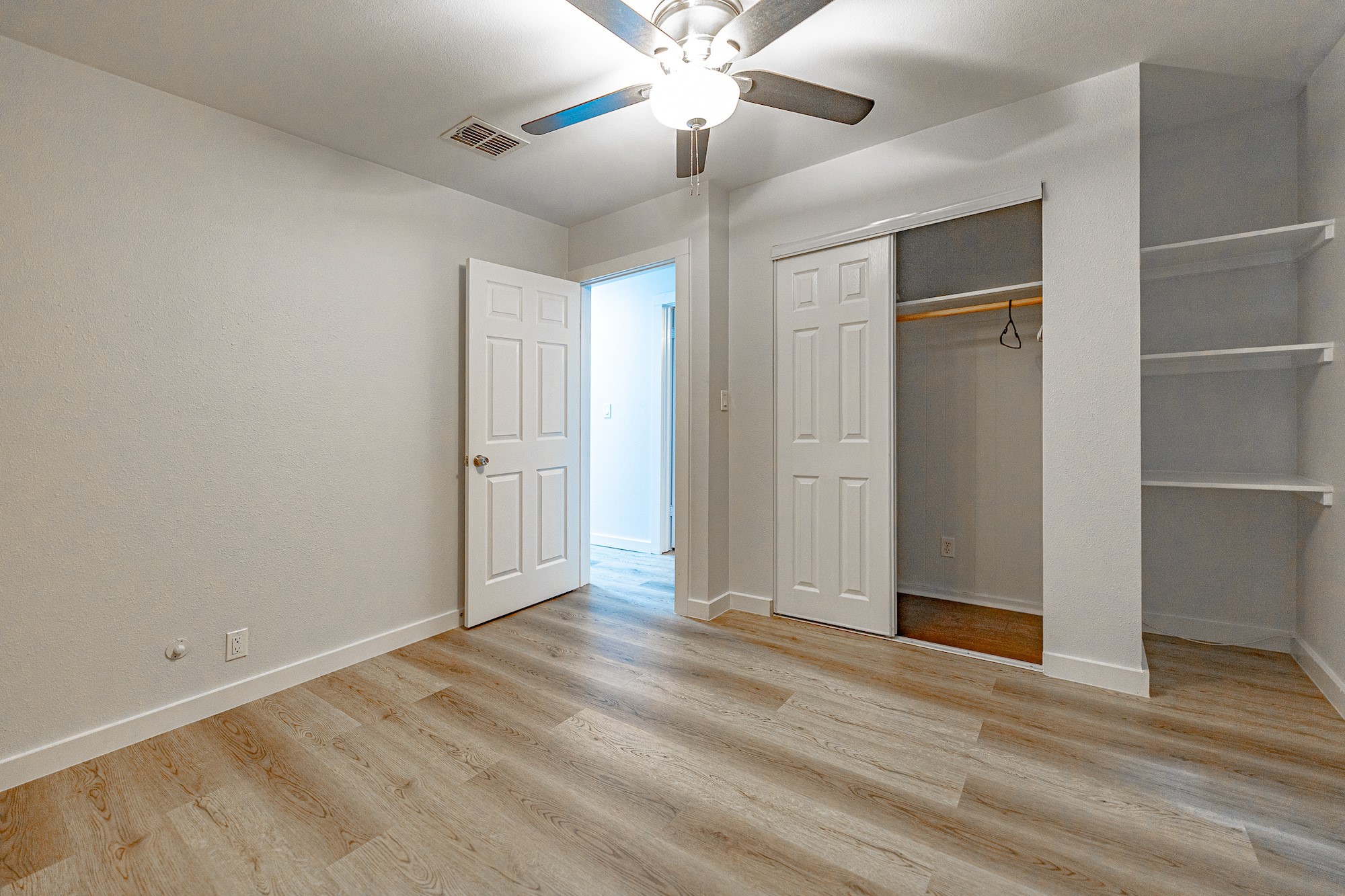 421 West Runk Street Shiner, TX 77984 - Photo 13 of 18 an empty room with wooden floor closet and windows