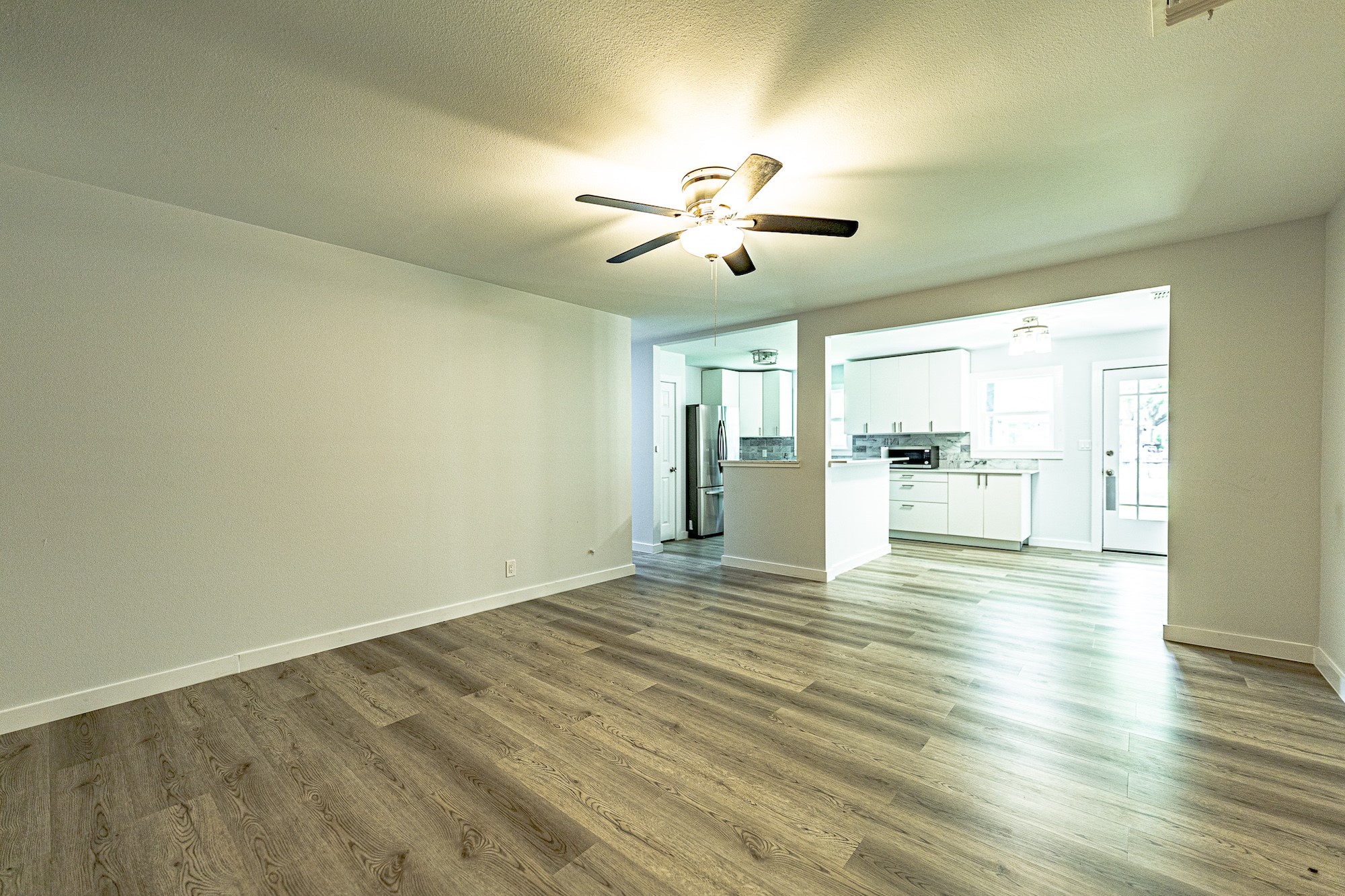 421 West Runk Street Shiner, TX 77984 - Photo 4 of 18 a view of an empty room with wooden floor and a window