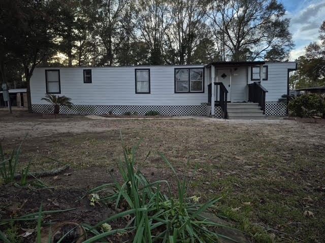 15110 Firetower Road Conroe, TX 77306 - Photo 3 of 14 a front view of a house with garden