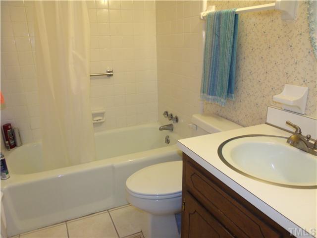 4509 Waterbury Road Raleigh, NC 27604 - Photo 12 of 13 a bathroom with a sink a toilet and a bathtub
