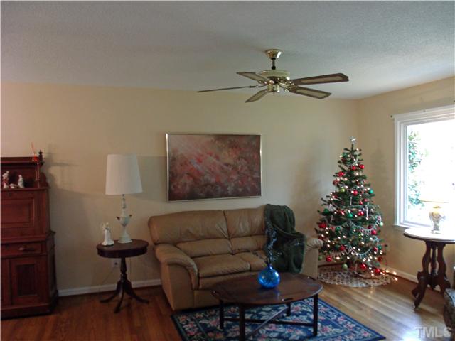 4509 Waterbury Road Raleigh, NC 27604 - Photo 2 of 13 a living room with furniture flowers and a window
