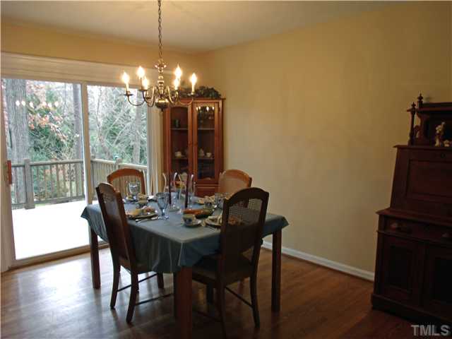 4509 Waterbury Road Raleigh, NC 27604 - Photo 4 of 13 a view of a dining room with furniture a chandelier and wooden floor