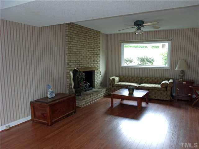 4509 Waterbury Road Raleigh, NC 27604 - Photo 5 of 13 a living room with furniture and a fireplace