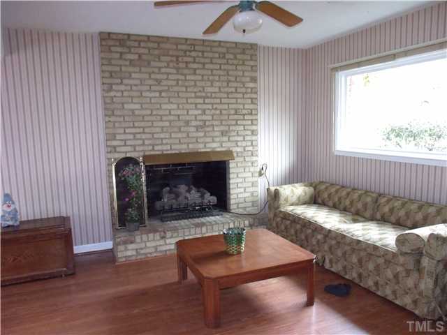 4509 Waterbury Road Raleigh, NC 27604 - Photo 6 of 13 a living room with furniture and a fireplace