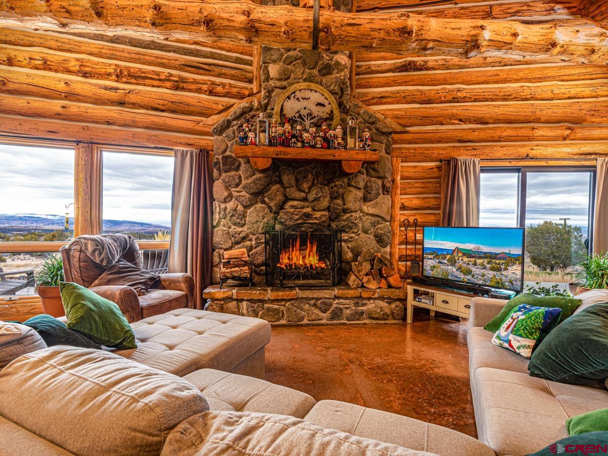 15371 2525th Road Cedaredge, CO 81413 - Photo 5 of 35 a living room with furniture a fireplace and city view