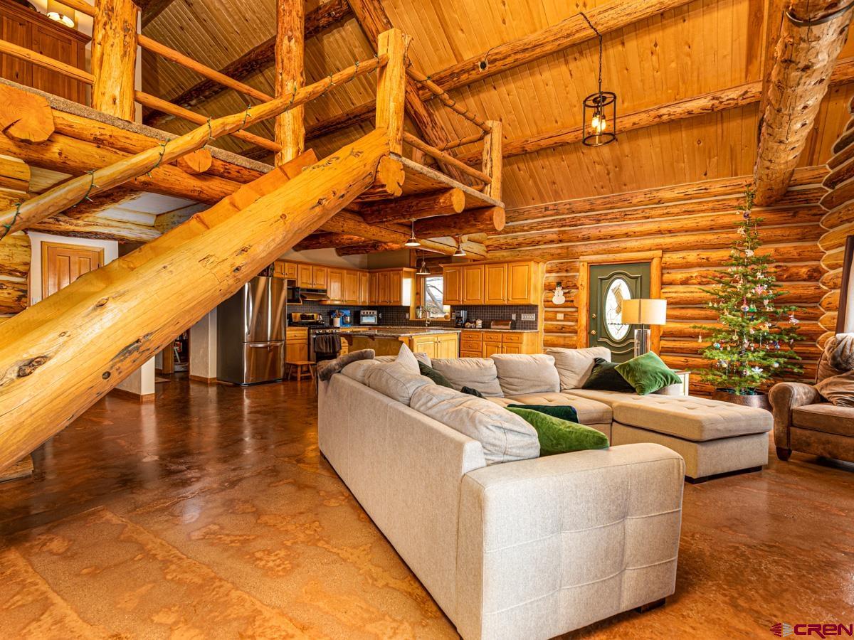 15371 2525th Road Cedaredge, CO 81413 - Photo 7 of 35 a living room with couches with wooden floor and pool