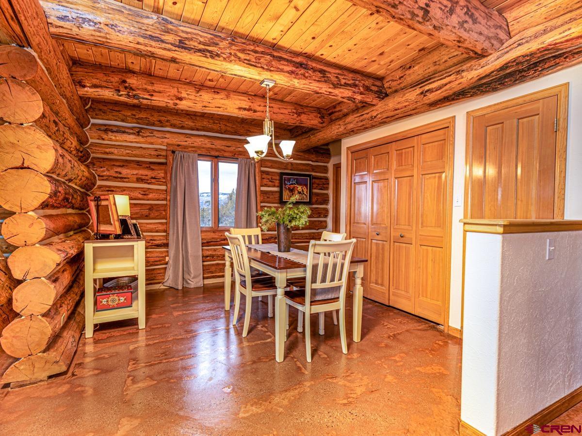 15371 2525th Road Cedaredge, CO 81413 - Photo 9 of 35 a dining room with furniture entryway and wooden floor