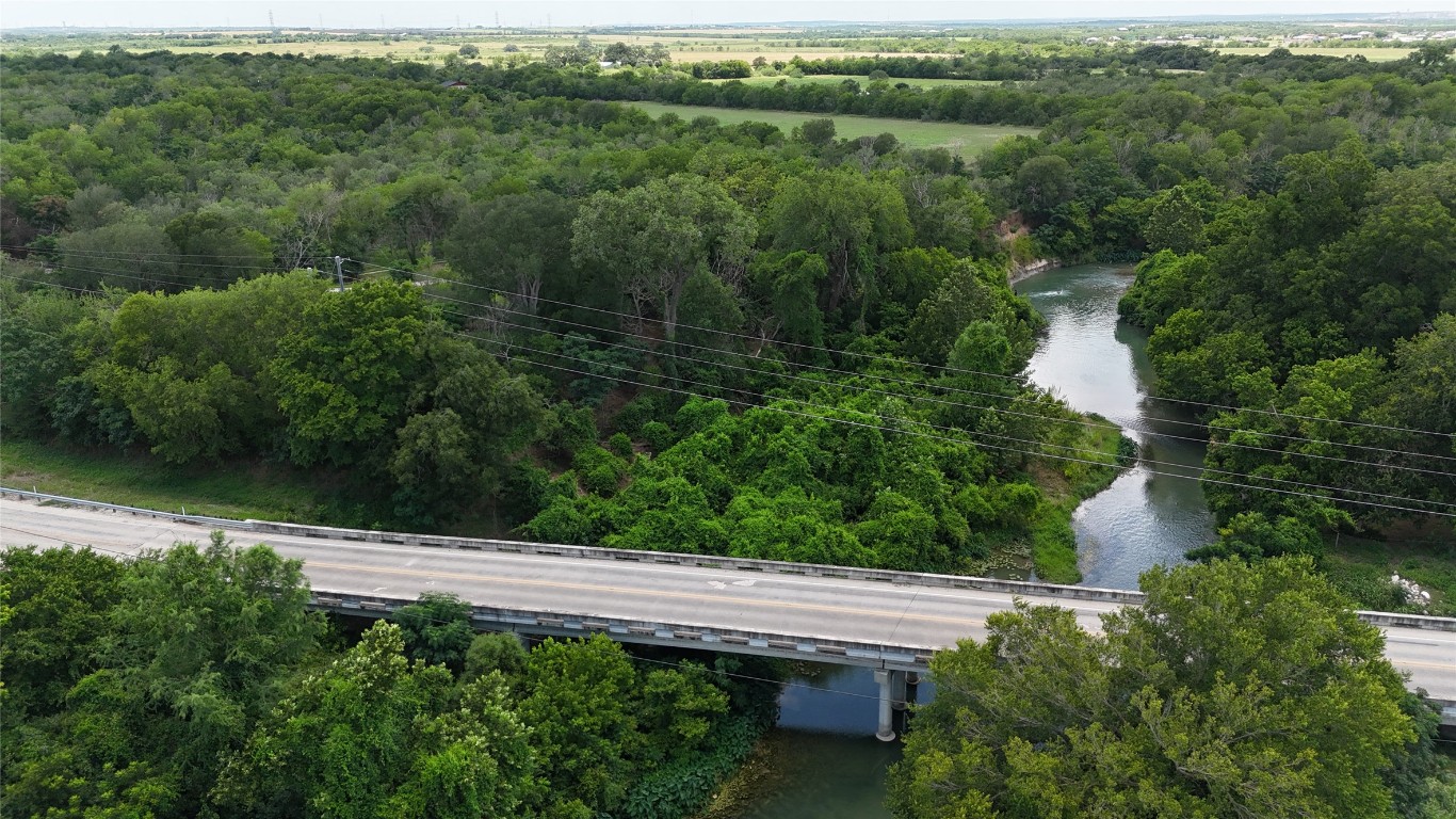 Lot 4-tbd Rd Martindale Tx 78655 Road Martindale, TX 78655 - Photo 9 of 23 a view of a lake with a yard and large trees