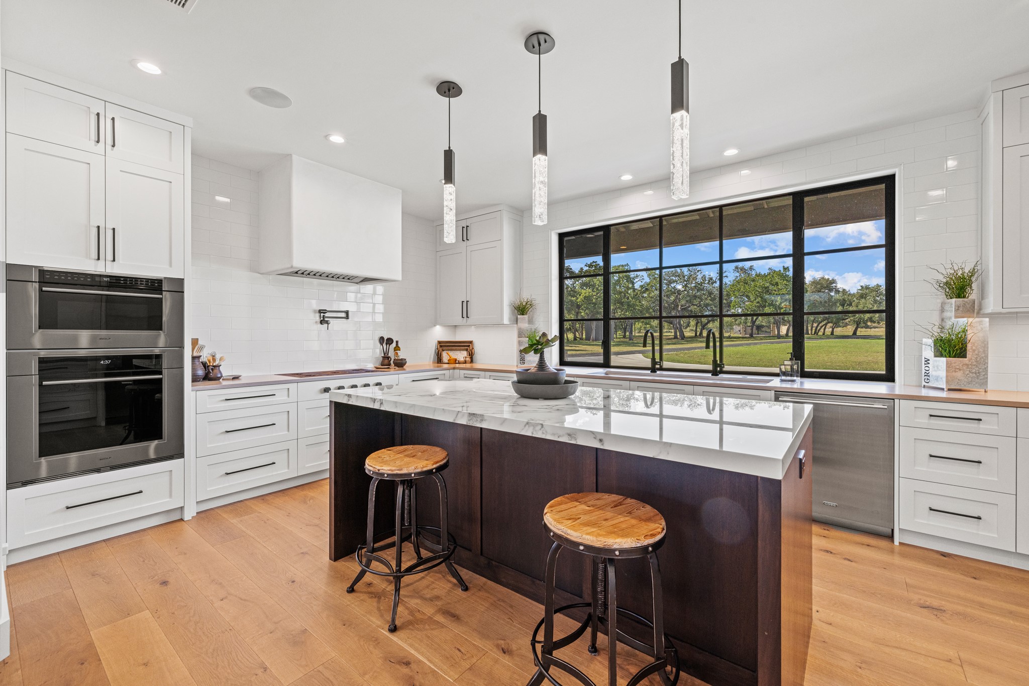 5862 Ranch Road 965 Llano, TX 78643 - Photo 11 of 40 a kitchen with stainless steel appliances granite countertop a stove a sink and a refrigerator with wooden floor