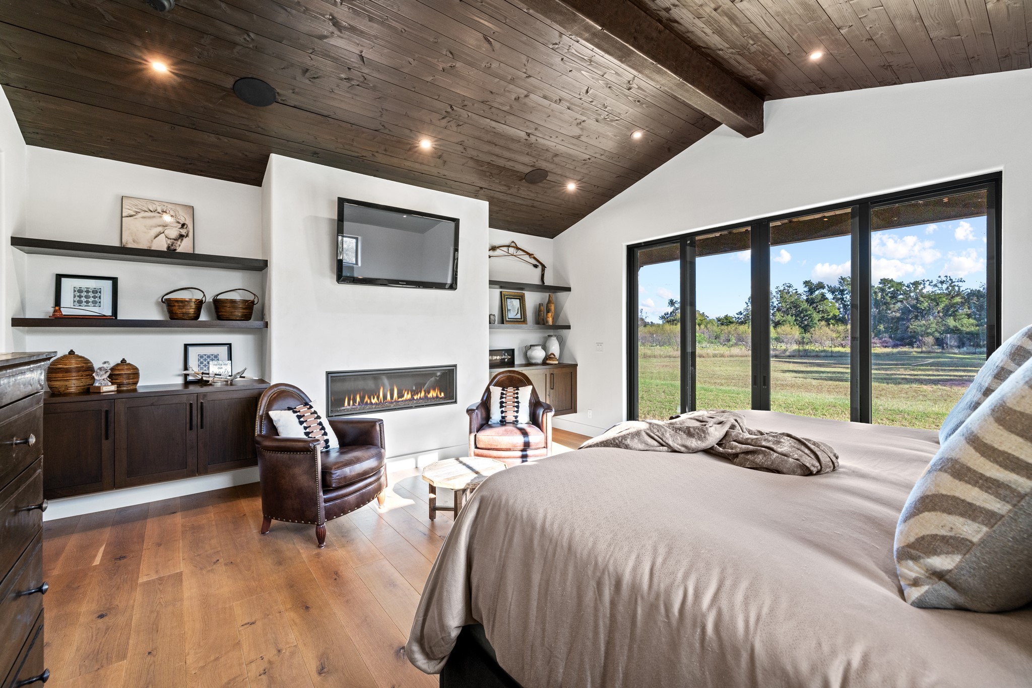 5862 Ranch Road 965 Llano, TX 78643 - Photo 13 of 40 a large bedroom with a large bed and a tv