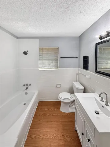 a view of a room with a ceiling fan and a window