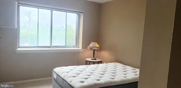 a dining room with furniture and a window