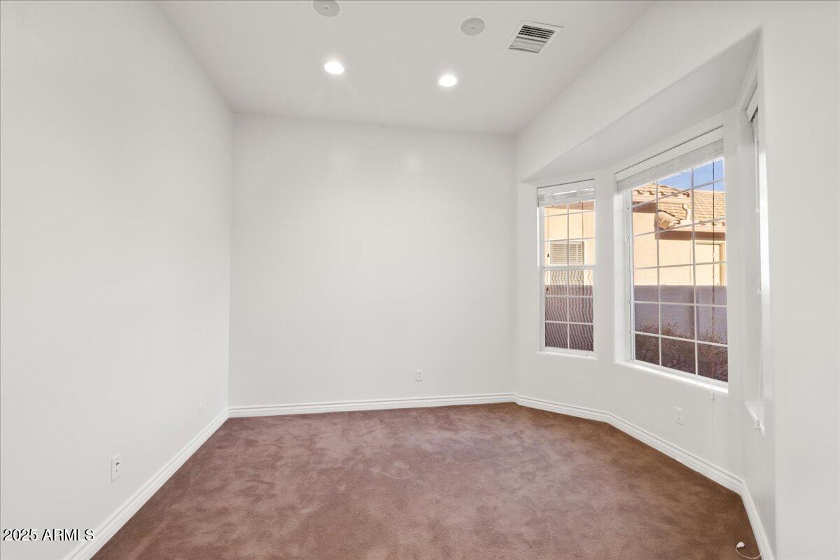 970 South Golf View Drive Cornville, AZ 86325 - Photo 43 of 48 an empty room with wooden floor and windows