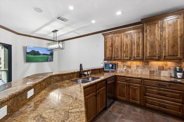 a kitchen that has a sink and a stove in it