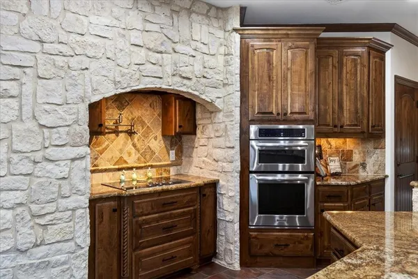 a kitchen with a stove and a refrigerator