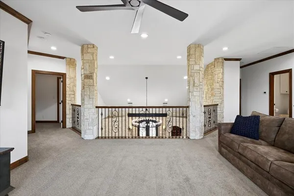 a living room with furniture and a ceiling fan