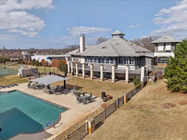 a view of a house with pool and chairs