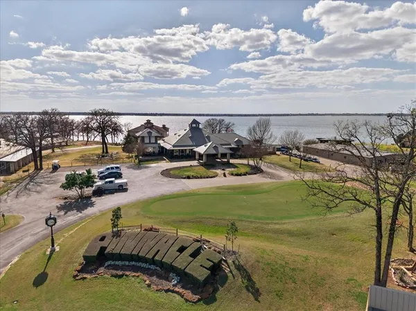 an aerial view of a house with swimming pool and outdoor seating