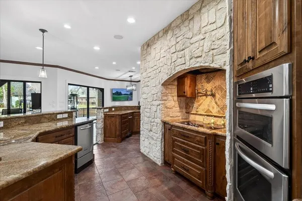 a kitchen with stove cabinets and stainless steel appliances