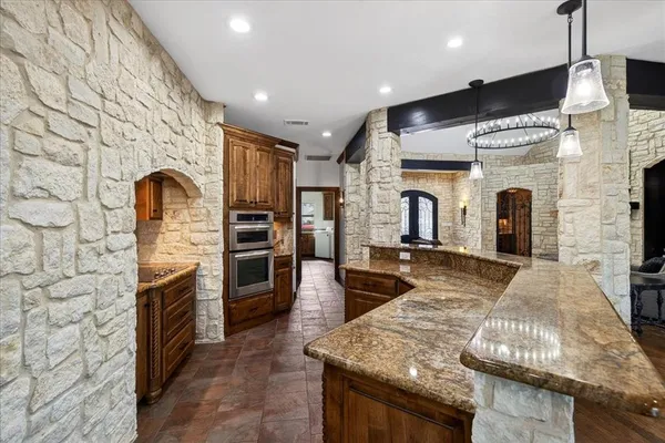 a kitchen with stainless steel appliances granite countertop a stove and a refrigerator