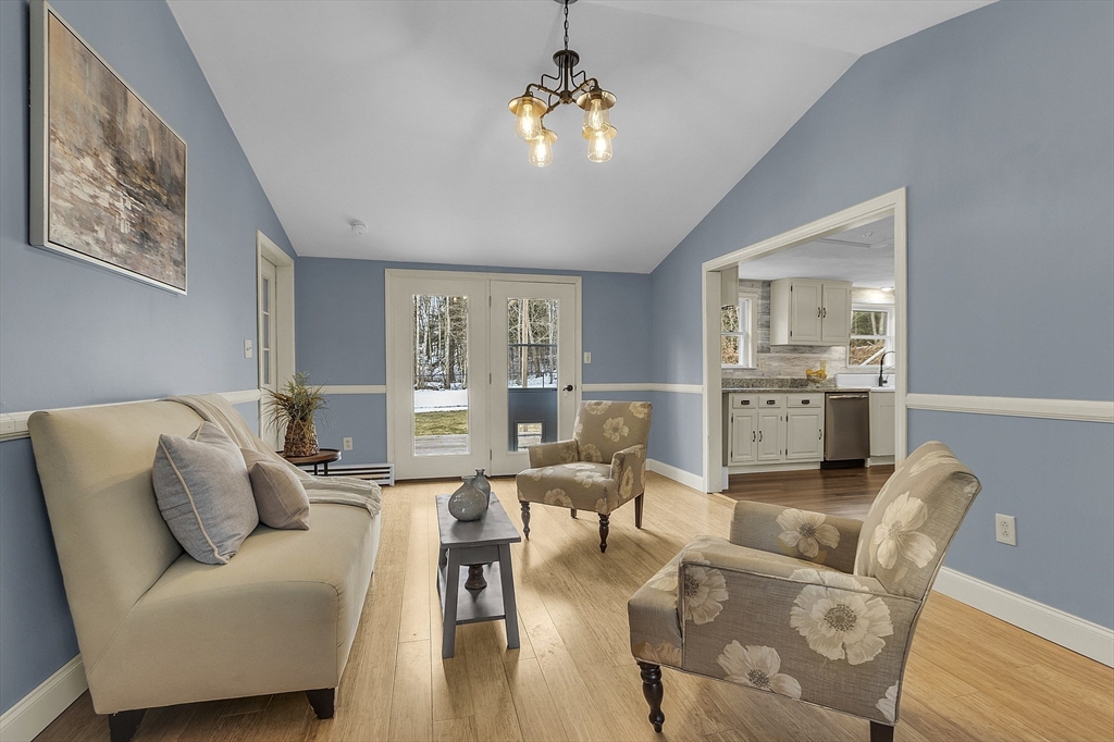 816 Patriots Road Templeton, MA 01468 - Photo 1 of 34 a living room with furniture and a chandelier
