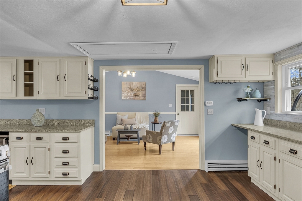 816 Patriots Road Templeton, MA 01468 - Photo 13 of 34 a kitchen with granite countertop a sink cabinets and wooden floor