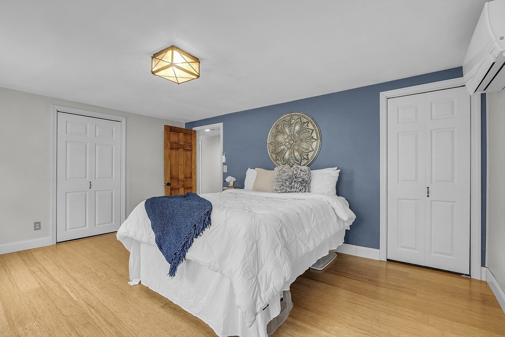 816 Patriots Road Templeton, MA 01468 - Photo 15 of 34 a bedroom with a bed and wooden floor