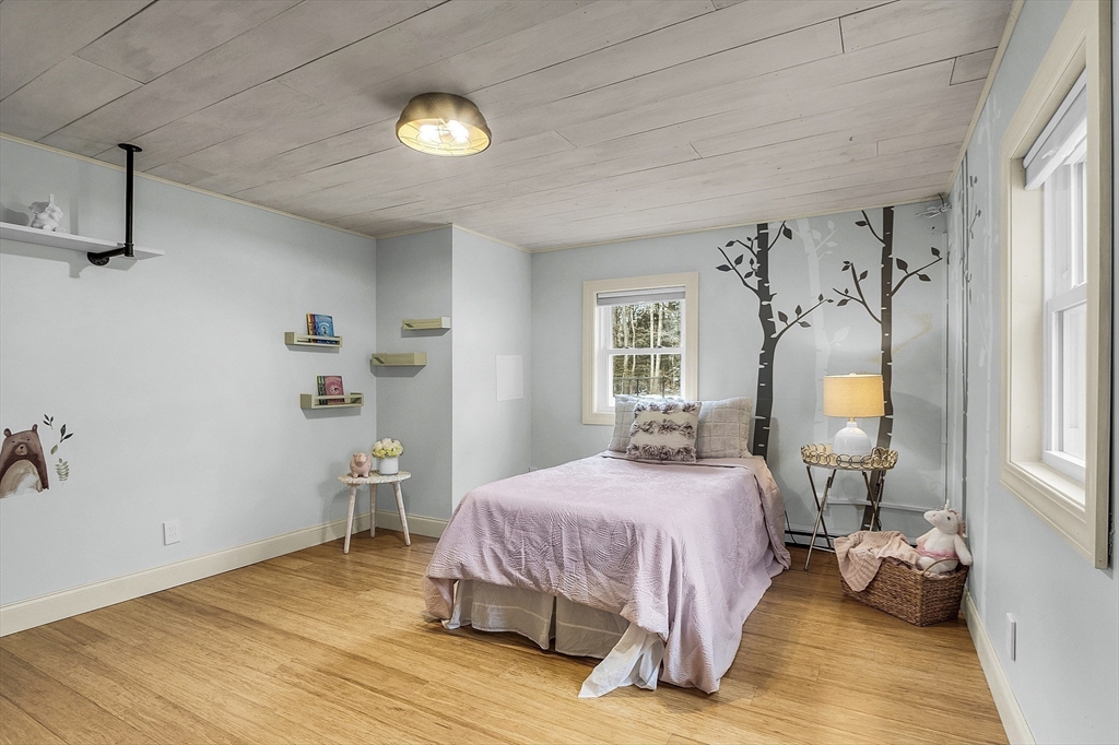 816 Patriots Road Templeton, MA 01468 - Photo 18 of 34 a bedroom with a bed and wooden floor