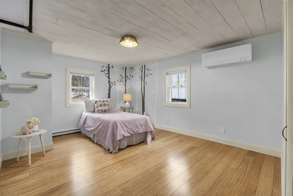 816 Patriots Road Templeton, MA 01468 - Photo 19 of 34 a spacious bedroom with a bed and wooden floor