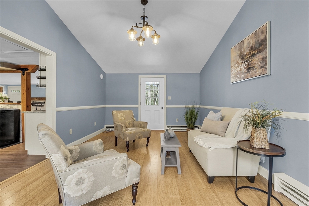 816 Patriots Road Templeton, MA 01468 - Photo 3 of 34 a living room with furniture and a chandelier