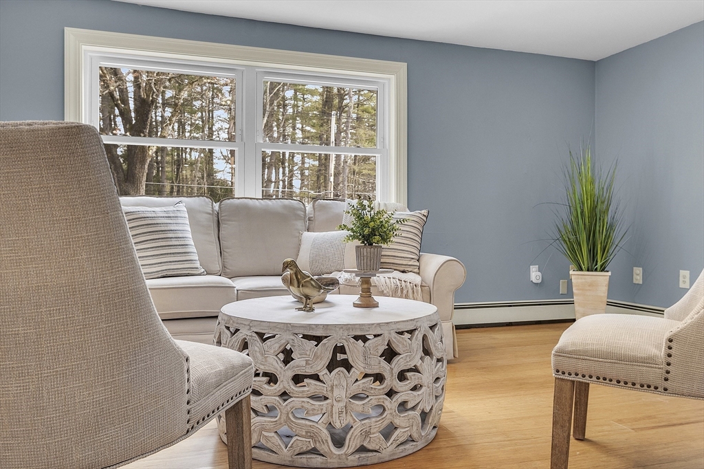 816 Patriots Road Templeton, MA 01468 - Photo 4 of 34 a dining room with furniture potted plants and wooden floor